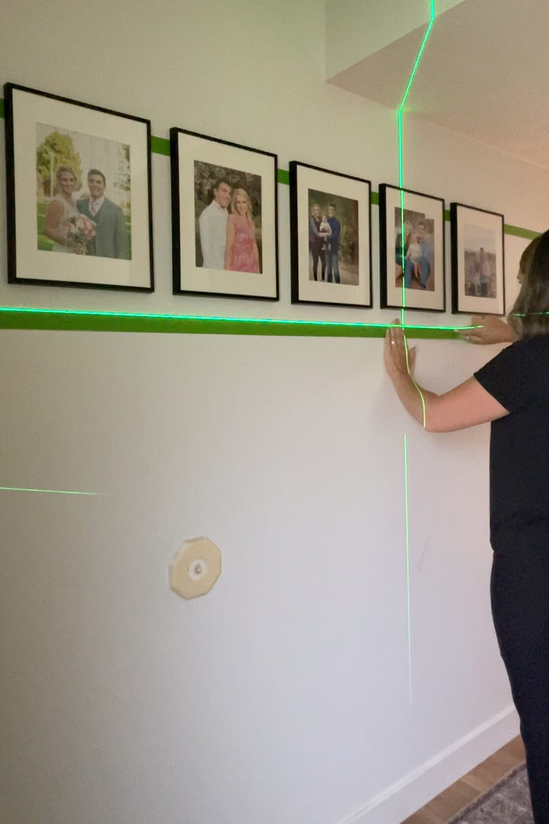Adding painters tape as a guide for hanging a gallery wall layout. 